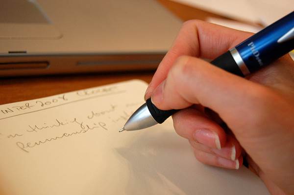 Hand Writing on a Paper with Pen