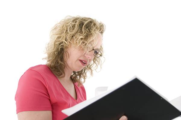 Blode Haired Woman Going Through Her Resume Folder