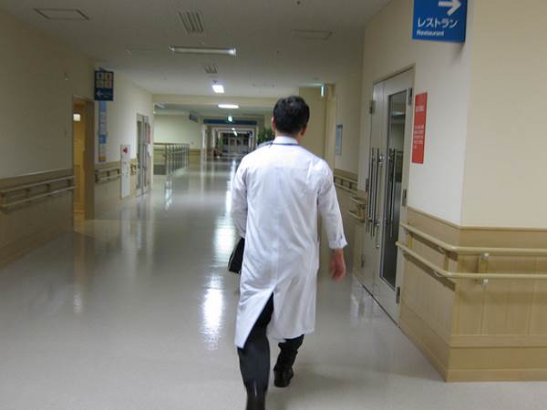 A Physician walking in a Hospital Corridor
