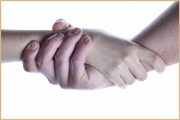 Networking - A Man and a Woman's Hands Clasping Each Other