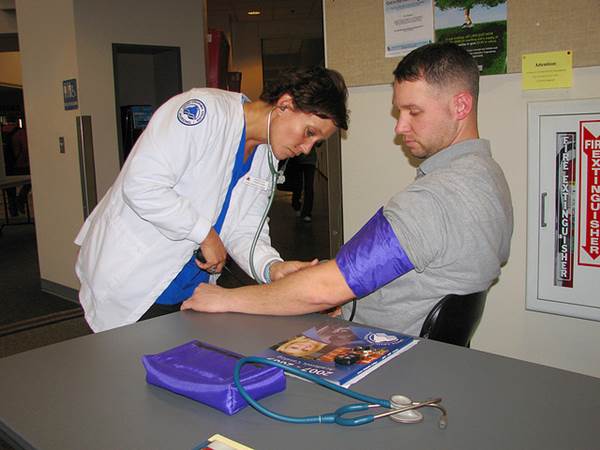 Nursing Student Working in the Field taking Blood Pressure