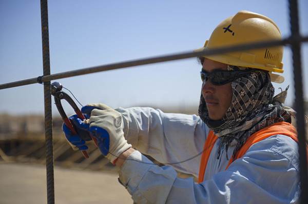 A Construction Worker Placing a Rebar